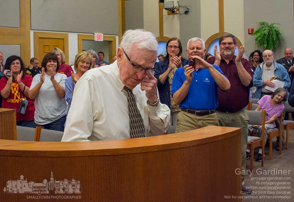 Former Westerville North principal and city council member Jim McCann reacts to a standing ovation given to him when he was named a "Westerville champion" at the city council meeting.